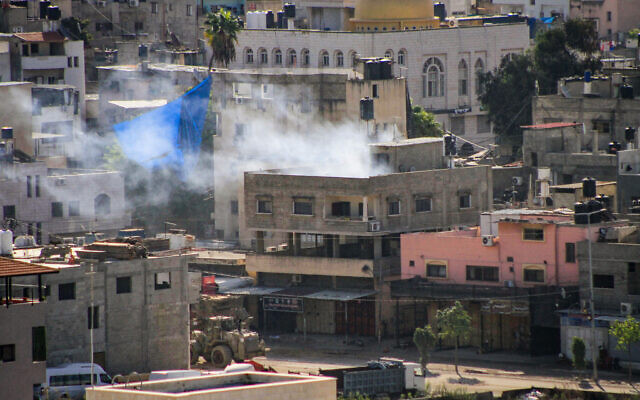 Israeli army vehicles seen during a military raid in the West Bank city of Tulkarm on October 19, 2023. (Nasser Ishtayeh/Flash90) Israeli army vehicles seen during a military raid in the West Bank city of Tulkarm on October 19, 2023. (Nasser Ishtayeh/Flash90)