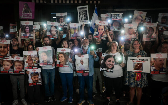 Families of Israelis held hostage by terrorists in Gaza hold up photographs of their abducted family members outside the Art Museum of Tel Aviv, October 21, 2023 (Avshalom Sassoni/Flash90) Families of Israelis held hostage by terrorists in Gaza hold up photographs of their abducted family members outside the Art Museum of Tel Aviv, October 21, 2023 (Avshalom Sassoni/Flash90)