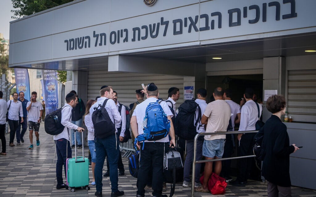 Illustrative: Ultra-Orthodox Jewish men arrive at the IDF recruitment center to volunteer for military service amid the ongoing war against Hamas, October 23, 2023. (Avshalom Sassoni/Flash90) Illustrative: Ultra-Orthodox Jewish men arrive at the IDF recruitment center to volunteer for military service amid the ongoing war against Hamas, October 23, 2023. (Avshalom Sassoni/Flash90)