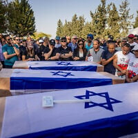 Family and friends attend the funeral of three members of the Sharabi family, Lian, Noya and Yahel, who were murdered by Hamas terrorists in Kibbutz Be'eri on October 7, 2023, in Moshav Kfar HaRif, southern Israel, October 25, 2023. (Chaim Goldberg/Flash90)