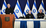 Prime Minister Benjamin Netanyahu speaks (left) as Defense Minister Yoav Gallant (center) and head of the National Unity party Benny Gantz (right) listen, during a joint press conference at the Defense Ministry in Tel Aviv. October 28, 2023. (Dana Kopel/POOL)
