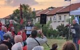 National Security Council chairman Tzachi Hanegbi (in blue shirt at far left) listens to anti-judicial overhaul protesters in front of his house in Mevaseret Zion on October 3, 2023. (Protest movement)