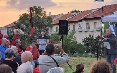 National Security Council chairman Tzachi Hanegbi (in blue shirt at far left) listens to anti-judicial overhaul protesters in front of his house in Mevaseret Zion on October 3, 2023. (Protest movement)