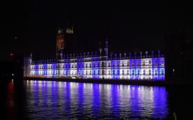 The Palace of Westminster, the home of the UK Houses of Parliament in London, is lit up in the colors of Israel’s flag for victims and hostages of Hamas attacks, Oct. 9, 2023. (Lucy North/PA Images via Getty Images, via JTA)