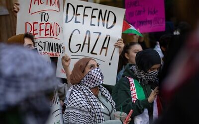 Illustrative: Students from Hunter College in New York City chant and hold up signs during an anti-Israel demonstration at the entrance of their campus on October 12, 2023. (Michael Nigro/Pacific Press/LightRocket via Getty Images, via JTA)