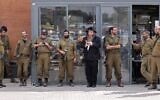 Israeli soldiers pray with a rabbi during a break in the southern Israeli city of Beit Kama, October 16, 2023. (Thomas Coex/AFP)