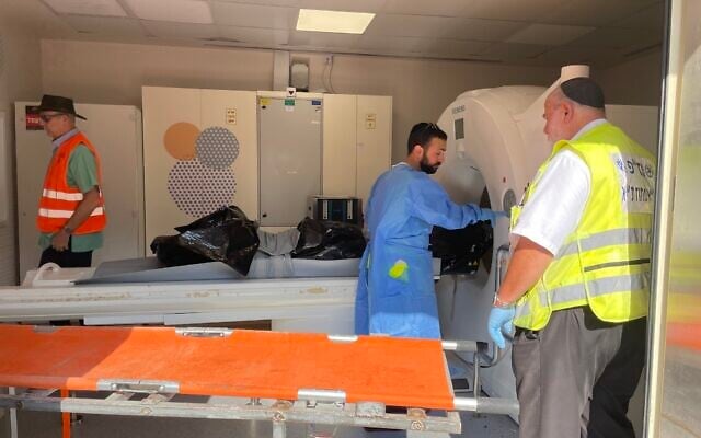 A victim of the murderous Hamas attack on southern Israeli communities on October 7, 2023 undergoes a CT scan at the National Center of Forensic Medicine (Abu Kabir) in Jaffa, October 16, 2023. (Renee Ghert-Zand/Times of Israel)