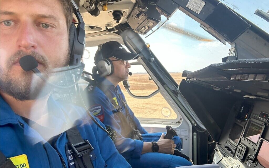 Michael Shamai (L) and fellow pilot Jorge Ordoñez fly a Magen David Adom air ambulance to evacuate injured from Hamas's October 7, 2023 terror attack, killing over 1,200 Israelis and injuring over 3,000. (Courtesy)