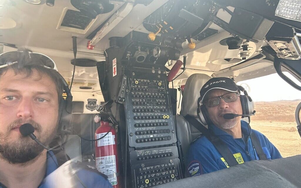 Michael Shamai (L) and fellow pilot Jorge Ordoñez fly a Magen David Adom air ambulance to evacuate injured from Hamas's October 7, 2023 terror attack, killing over 1,200 Israelis and injuring over 3,000. (Courtesy)