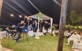 Ishay Ribo singing at the impromptu backyard wedding of Maor and Gal Peretz on October 9, 2023 (Courtesy Yossi Zer)