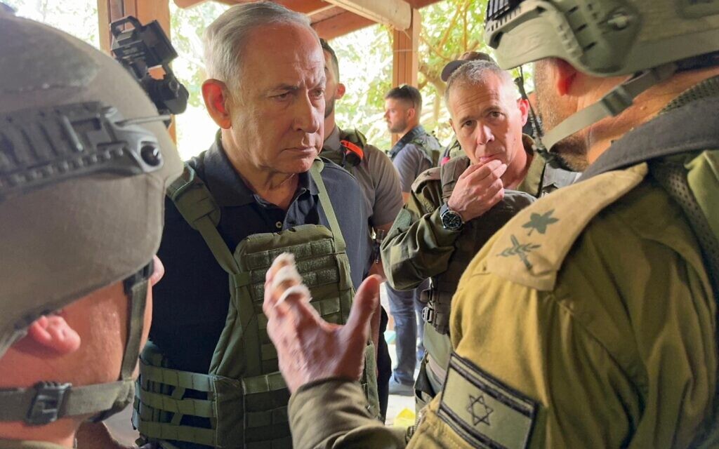 Prime Minister Benjamin Netanyahu speaks to IDF officers at one of the communities hit by the deadly Hamas assault, on October 14, 2023 (Avi Ohayon/GPO) Prime Minister Benjamin Netanyahu speaks to IDF officers at one of the communities hit by the deadly Hamas assault, on October 14, 2023 (Avi Ohayon/GPO)