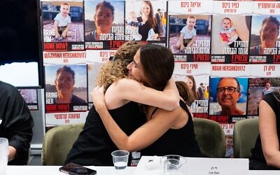 Adva Gutman Tirosh and Lee Dan, whose family members were taken captive in Gaza a week earlier hug following a press conference in Tel Aviv demanding medical attention for their loved ones, October 14, 2023. (Courtesy Nadav Cohen Yonatan)