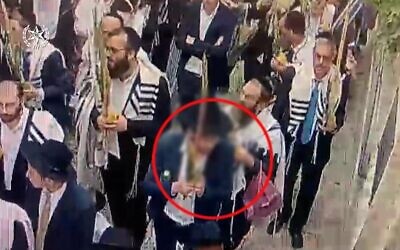 A Jewish man seen spitting at Christians in Jerusalem during a parade for the festival of Sukkot on October 4, 2023. (Israel Police)