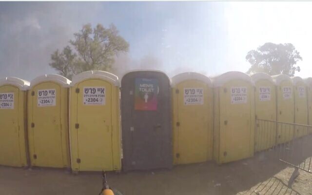 Hamas terrorists fire at Israelis hiding in port-o-potties near Re'im in southern Israel on October 7, 2023. (South First Responders) Hamas terrorists fire at Israelis hiding in port-o-potties near Re'im in southern Israel on October 7, 2023. (South First Responders)