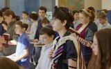Students praying at Schechter Manhattan. (Screenshot via JTA)