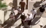 Religious Jews standing atop tombs at the Bab al-Rahma cemetery in Jerusalem. (X screenshot)