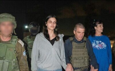 Natalie Raanan, 2nd left, Judith Raanan, right, are seen upon arrival in Israel after being released from Hamas captivity as government hostage envoy Gal Hirsch, center, holds their hands, October 20, 2023. (Courtesy)