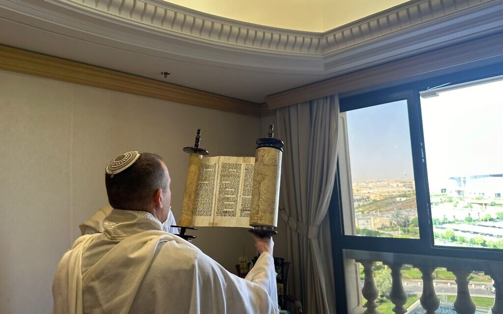A member of Communications Minister Shlomo Karhi's delegation holds up a Torah scroll during a morning prayer service in Riyadh, Saudi Arabia, October 3, 2023. (Spokesman's Office, Communications Ministry) A member of Communications Minister Shlomo Karhi's delegation holds up a Torah scroll during a morning prayer service in Riyadh, Saudi Arabia, October 3, 2023. (Spokesman's Office, Communications Ministry)