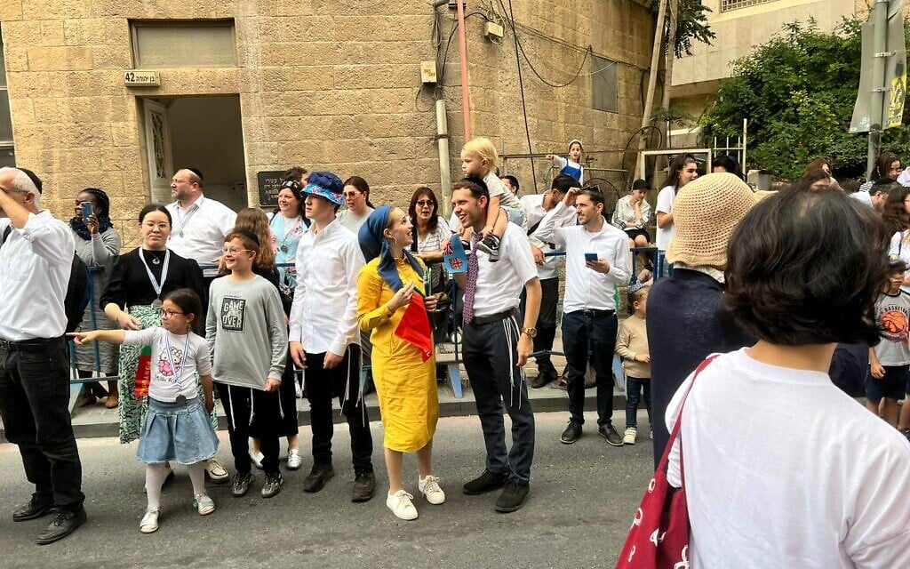 Israelis watch the International Christian Embassy of Jerusalem march, October 4, 2023 (Lazar Berman/The Times of Israel)