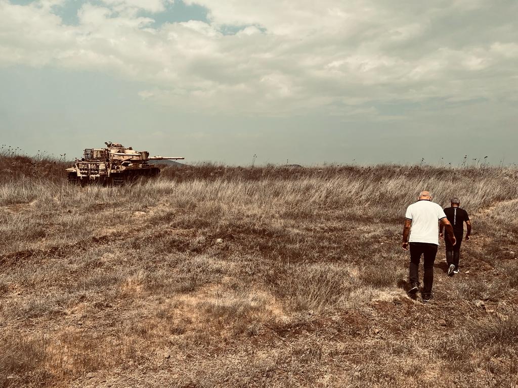 Yom Kippur War veterans Roni Mansur (in white) and Moshe Kahalani walk toward the tank Mansur fought in during the first day of the 1973 Yom Kippur War, September 13, 2023 (Lazar Berman/Times of Israel) Yom Kippur War veterans Roni Mansur (in white) and Moshe Kahalani walk toward the tank Mansur fought in during the first day of the 1973 Yom Kippur War, September 13, 2023 (Lazar Berman/Times of Israel)
