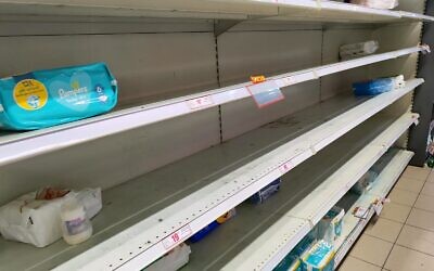 Nearly empty shelves in the baby care section, at a Rami Levy supermarket in Pardes Hannah-Karkur, on October 10, 2023. (Gavriel Fiske/Times of Israel)
