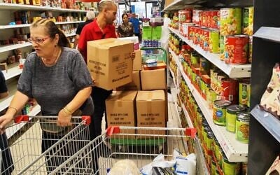 The busy aisles at a Rami Levy supermarket in Pardes Hannah Karkur, on October 10, 2023. (Gavriel Fiske/Times of Israel)