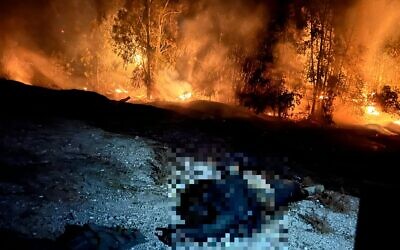 The body of a Hamas terrorist lies near Route 232, October 11, 2023 (Lazar Berman/The Times of Israel)