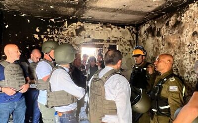 Colonel Golan Vach (R) speaks to French parliamentarians in Kfar Aza, October 16, 2023 (Lazar Berman/The Times of Israel)
