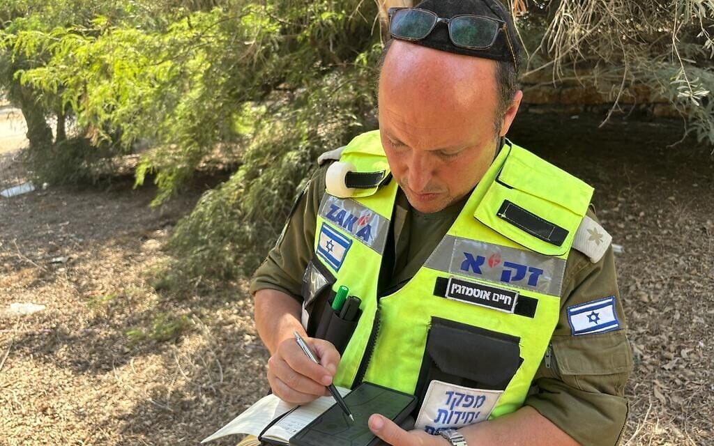 File - IDF reservist Haim Otmazgin commands a ZAKA mission to search for remains in Kibbutz Be'eri, devastated by the Hamas attack on October 7, photographed on October 20, 2023 (Carrie Keller-Lynn/The Times of Israel)