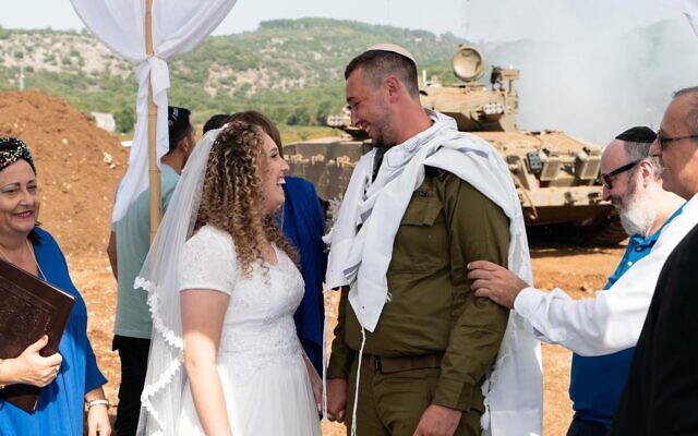 Shirel Tayeb and Reuven Lebetkin are married at Israel's northern border on October 23, 2023. Their planned wedding date took place during the Israel-Hamas war and they chose to move forward with changes. (Courtesy of Lebetkin via JTA)
