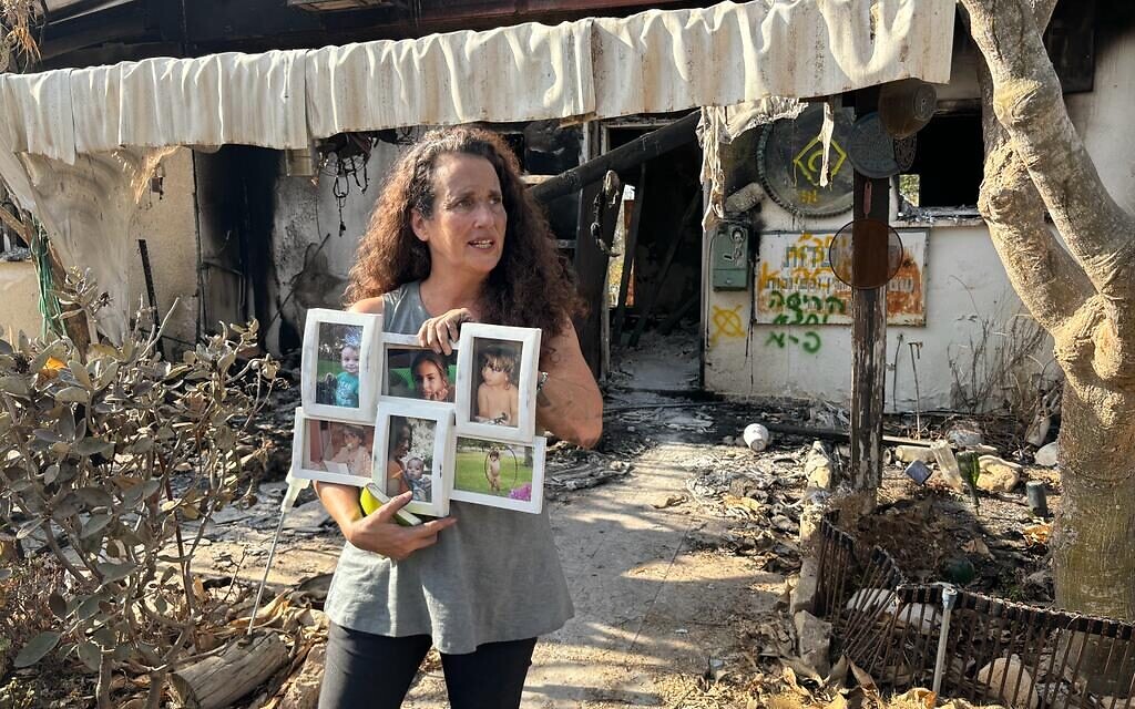 FILE - Hadas Calderon holds pictures of her children, two of whom were held captive by Hamas, at Kibbutz Nir Oz, October 30, 2023. (Carrie Keller-Lynn / The Times of Israel) FILE - Hadas Calderon holds pictures of her children, two of whom were held captive by Hamas, at Kibbutz Nir Oz, October 30, 2023. (Carrie Keller-Lynn / The Times of Israel)
