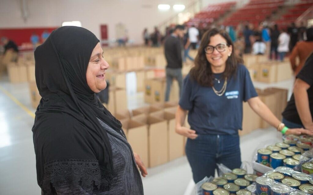Volunteers at the Rahat community center sorting goods and creating packages, October 2023. (courtesy)