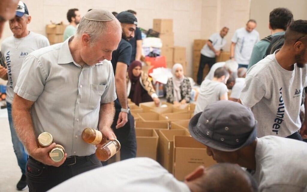 Volunteers at the Rahat community center sorting goods and creating packages, October 2023. (courtesy)
