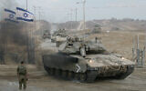 The last Israeli tanks exit the Gaza Strip through the Kissufim crossing, which led to the now-evacuated Gush Katif bloc settlements, 12 September 2005. (Yoav Lemmer/AFP)
