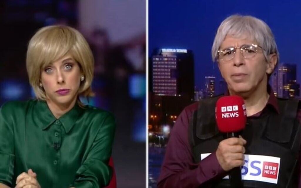 Liat Harlev as a BBC anchor, and Yuval Semo, playing Middle East correspondent Harry Whiteguilt, lampoon a BBC report about the bombing of a Gaza hospital, in a skit screened on October 28, 2023. (Screenshot from Eretz Nehederet. Keshet Channel 12, used in accordance with Clause 27a of the Copyright Law) Liat Harlev as a BBC anchor, and Yuval Semo, playing Middle East correspondent Harry Whiteguilt, lampoon a BBC report about the bombing of a Gaza hospital, in a skit screened on October 28, 2023. (Screenshot from Eretz Nehederet. Keshet Channel 12, used in accordance with Clause 27a of the Copyright Law)