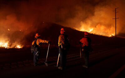 Firefighters monitor as flames consume brush along Gilman Springs Road during the Rabbit Fire, July 14, 2023, in Moreno Valley, California. (AP Photo/Eric Thayer, File)