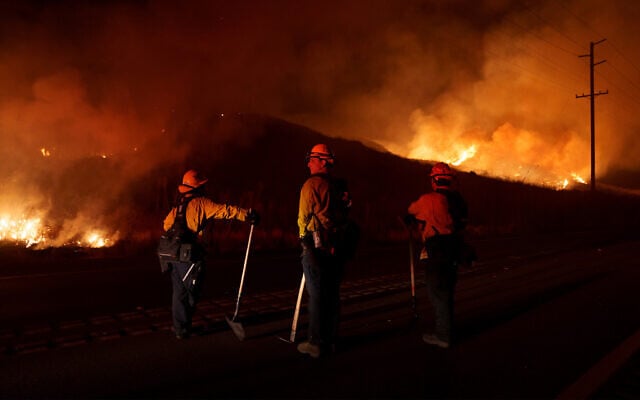 Firefighters monitor as flames consume brush along Gilman Springs Road during the Rabbit Fire, July 14, 2023, in Moreno Valley, California. (AP Photo/Eric Thayer, File) Firefighters monitor as flames consume brush along Gilman Springs Road during the Rabbit Fire, July 14, 2023, in Moreno Valley, California. (AP Photo/Eric Thayer, File)