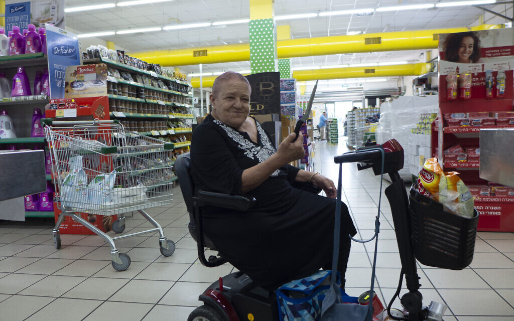 Batsheva Dahan shows the knife she keeps in her mobility scooter in case she encounters terrorists in Ofakim on October 11, 2023. (Canaan Lidor/Times of Israel) Batsheva Dahan shows the knife she keeps in her mobility scooter in case she encounters terrorists in Ofakim on October 11, 2023. (Canaan Lidor/Times of Israel)
