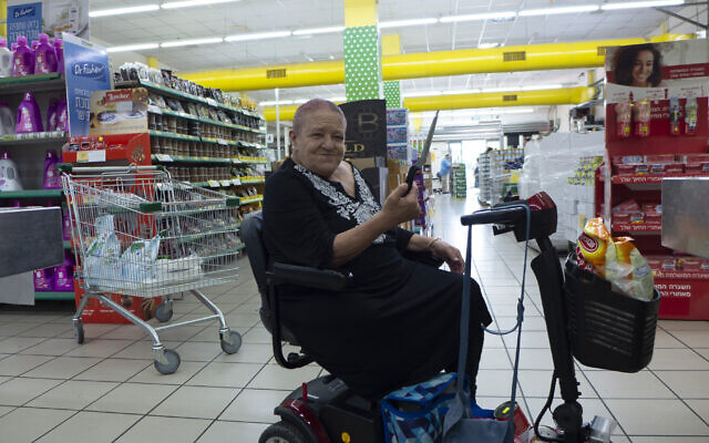 Batsheva Dahan shows the knife she keeps in her mobility scooter in case she encounters terrorists in Ofakim on October 11, 2023. (Canaan Lidor/Times of Israel)