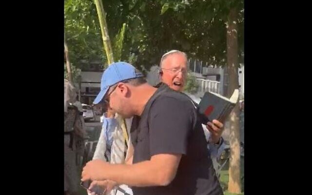 A protester tackling Rabbi Leo Dee as he prays at Dizengoff Square in Tel Aviv, Israel on October 5, 2023. (Video screenshot; used in accordance with Clause 27a of the Copyright Law) A protester tackling Rabbi Leo Dee as he prays at Dizengoff Square in Tel Aviv, Israel on October 5, 2023. (Video screenshot; used in accordance with Clause 27a of the Copyright Law)