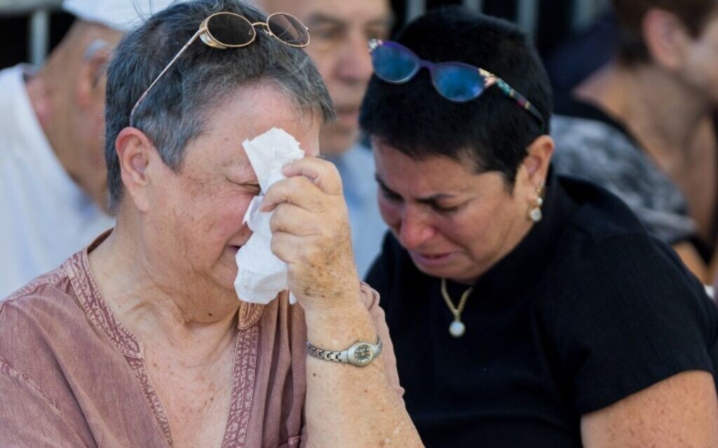 Family and friends attend the funeral of five members of the Kutz family, Livnat and Aviv and their three children Rotem, Yonatan and Yiftach, on October 17, 2023. The Kutz family was killed by Hamas terrorists, in their home in Kfar Aza, southern Israel, on October 7, 2023. (Flash90) Family and friends attend the funeral of five members of the Kutz family, Livnat and Aviv and their three children Rotem, Yonatan and Yiftach, on October 17, 2023. The Kutz family was killed by Hamas terrorists, in their home in Kfar Aza, southern Israel, on October 7, 2023. (Flash90)
