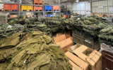 Illustrative: Uniforms and protective vests being prepared for distribution to reserve soldiers, October 10, 2023. (Israel Defense Forces)
