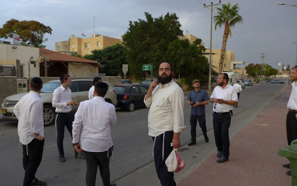Daniel Mualem, toting a plastic bag, looks at the house of Rachel and David Edry in Ofakim, Israel, on October 9, 2023. (Canaan Lidor/Times of Israel) Daniel Mualem, toting a plastic bag, looks at the house of Rachel and David Edry in Ofakim, Israel, on October 9, 2023. (Canaan Lidor/Times of Israel)