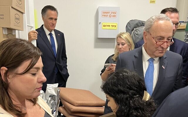 Senator Chuck Schumer, right, and Senator Mitt Romney, in back, shelter with aides in Tel Aviv during a rocket attack on October 15, 2023. (used in accordance with Clause 27a of the Copyright Law) Senator Chuck Schumer, right, and Senator Mitt Romney, in back, shelter with aides in Tel Aviv during a rocket attack on October 15, 2023. (used in accordance with Clause 27a of the Copyright Law)