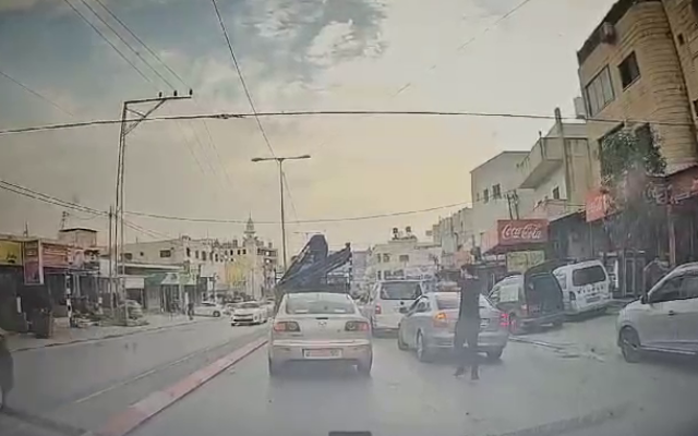 Dashcam footage shows a Palestinian terrorist opening fire at close range at an Israeli car in the West Bank town of Huwara, October 5, 2023. (Courtesy) Dashcam footage shows a Palestinian terrorist opening fire at close range at an Israeli car in the West Bank town of Huwara, October 5, 2023. (Courtesy)