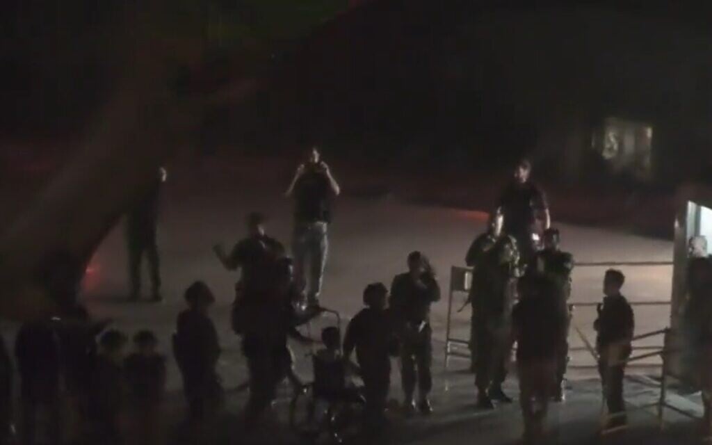 A person who appears to be Yocheved Lifshitz seen exiting a military helicopter on the roof of Ichilov hospital in Tel Aviv on October 24, 2023. (screen capture)