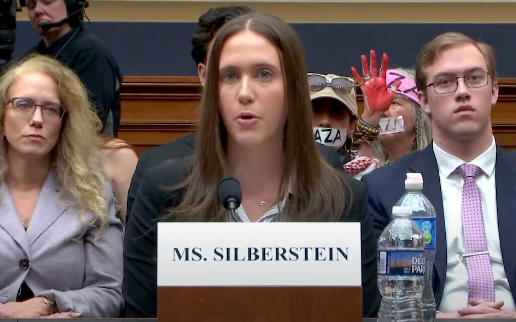 Illustrative: Amanda Silberstein, a Jewish Cornell University student, testifies before the US House on the antisemitism she has experienced on campus; pro-Palestinian, anti-Israel protesters demonstrate behind her, Washington, DC, November 8, 2023. (Screenshot via YouTube) Illustrative: Amanda Silberstein, a Jewish Cornell University student, testifies before the US House on the antisemitism she has experienced on campus; pro-Palestinian, anti-Israel protesters demonstrate behind her, Washington, DC, November 8, 2023. (Screenshot via YouTube)