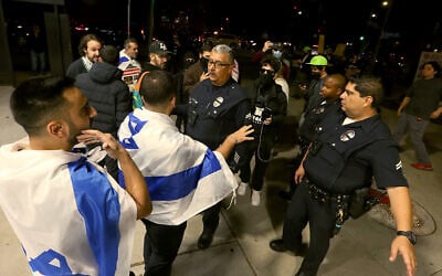 LAPD officers separate pro-Israel and pro-Palestinian activists outside The Museum of Tolerance, during a private screening of footage showing Hamas's October 7 massacre, Los Angeles, November 8, 2023. (Luis Sinco/Los Angeles Times via Getty Images/JTA)