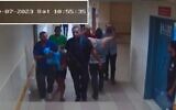 Hamas terrorists bring a hostage into Shifa Hospital as seen on surveillance footage from October 7, 2023. (IDF)