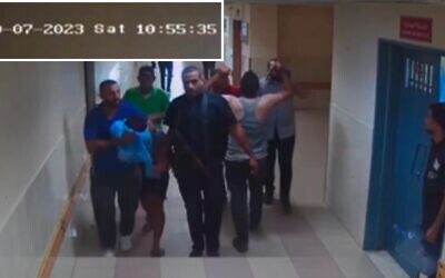 Hamas terrorists bring a hostage into Shifa Hospital as seen on surveillance footage from October 7, 2023. (IDF)